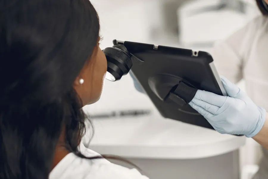Dermatologist using a dermatoscope during a skin examination