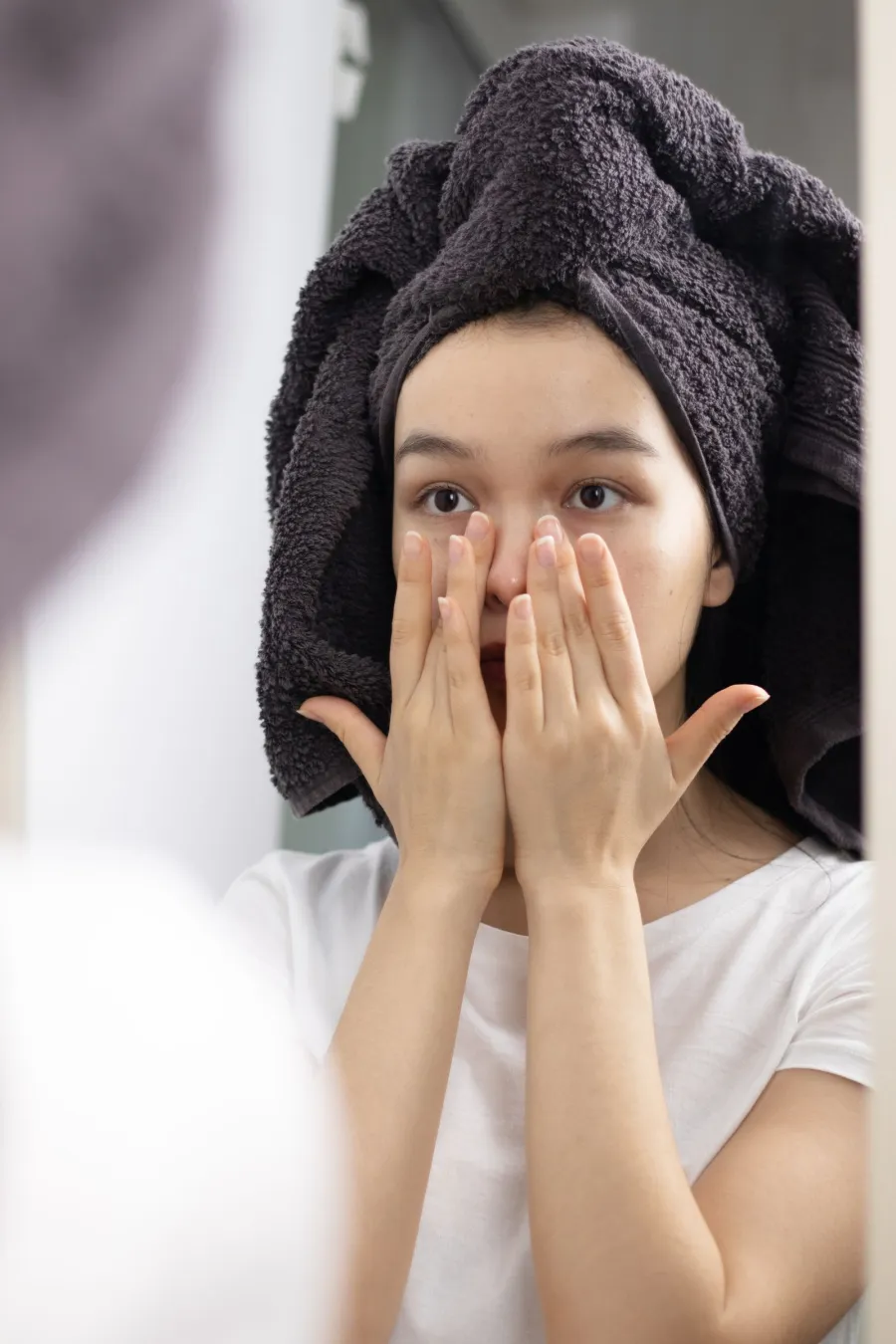 Person patting face while looking in a mirror