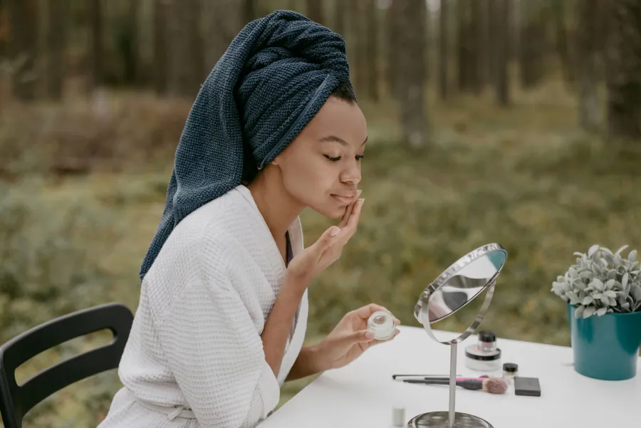Person applying skincare cream, illustrative image