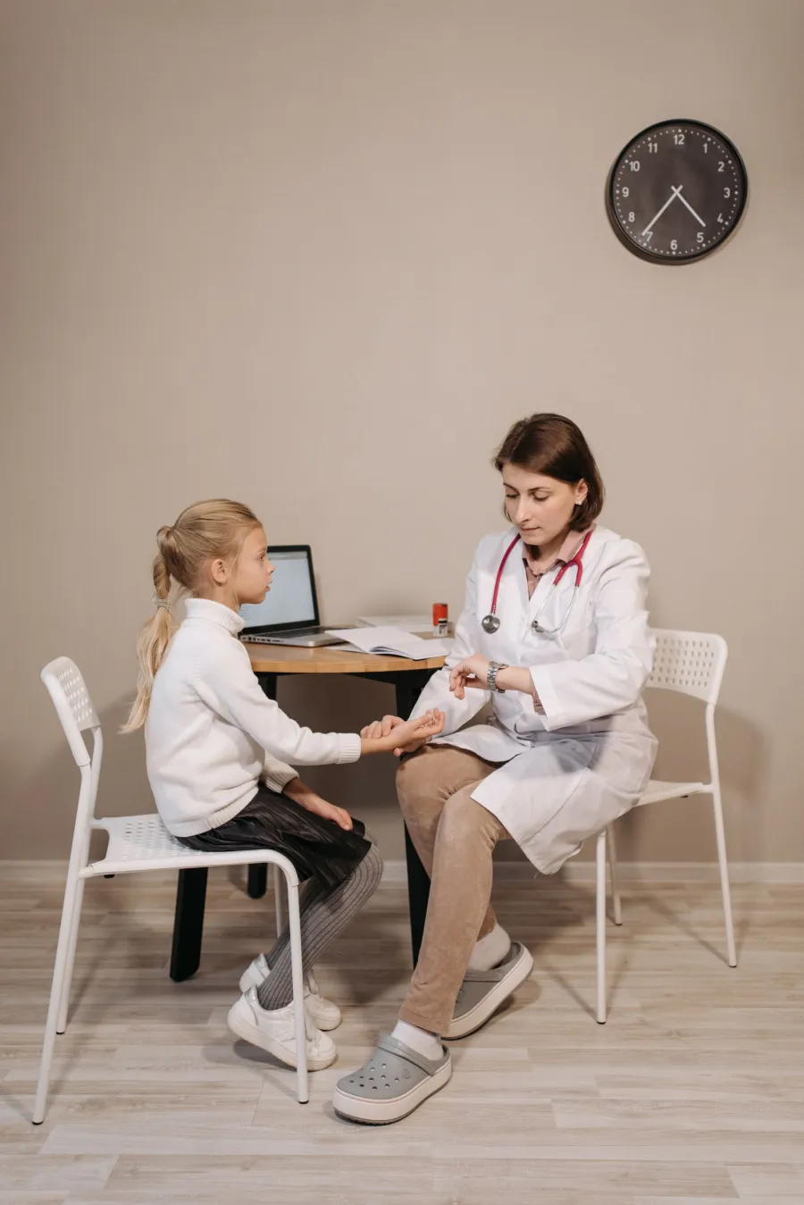 Pediatrician performing a routine checkup on a young patient