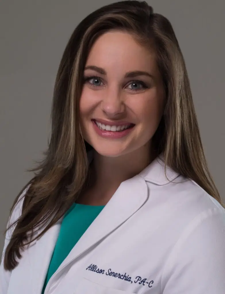 A smiling professional headshot of Allison Senerchia, wearing a white coat.