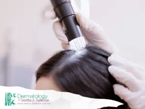 Scalp examination with a specialized device, focusing on hair and scalp health assessment by a professional.