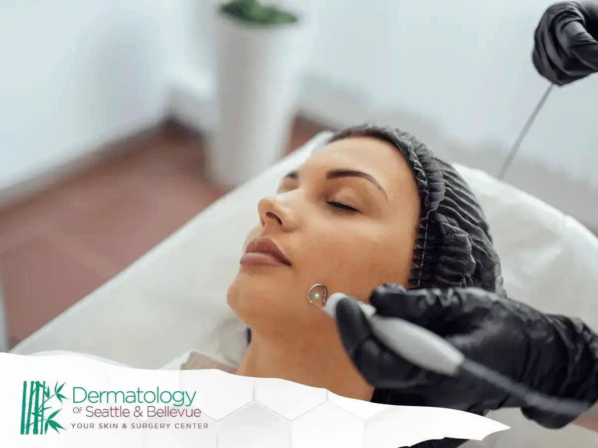 A woman receiving a professional skincare treatment on her cheek with specialized tools, performed by a trained specialist