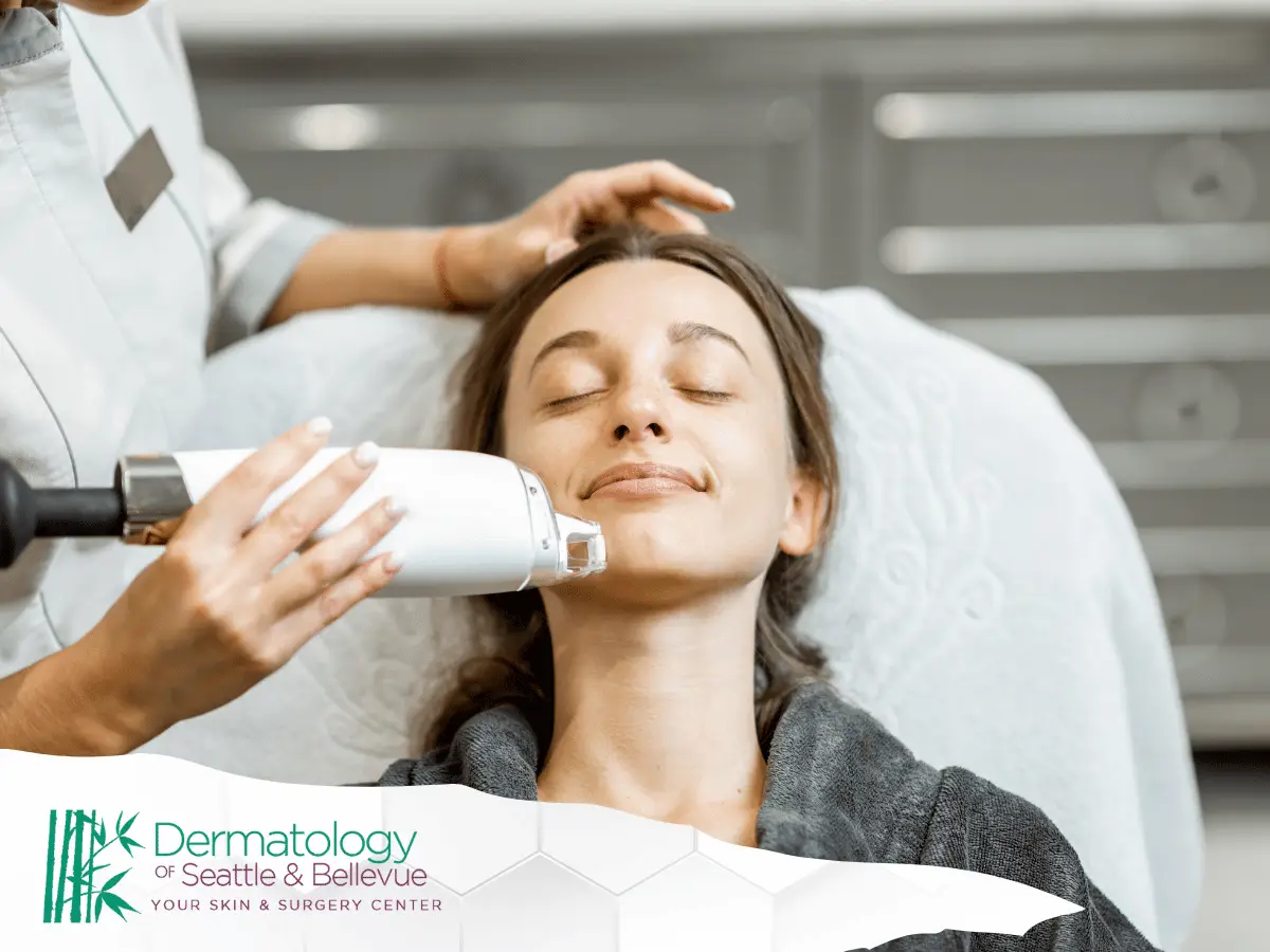 Woman receiving a facial treatment at a dermatology clinic, appearing relaxed. Treatment provided by Dermatology of Seattle & Bellevue.