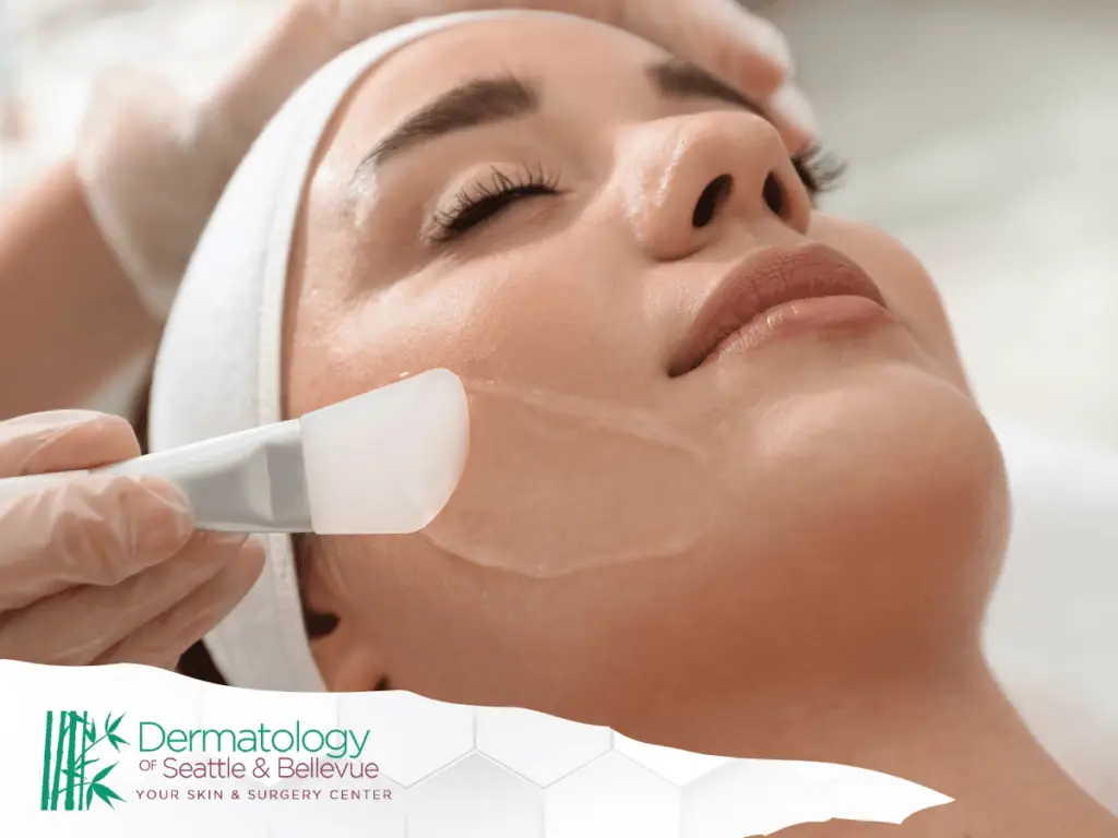 Close-up of woman receiving facial treatment with applicator on cheek.