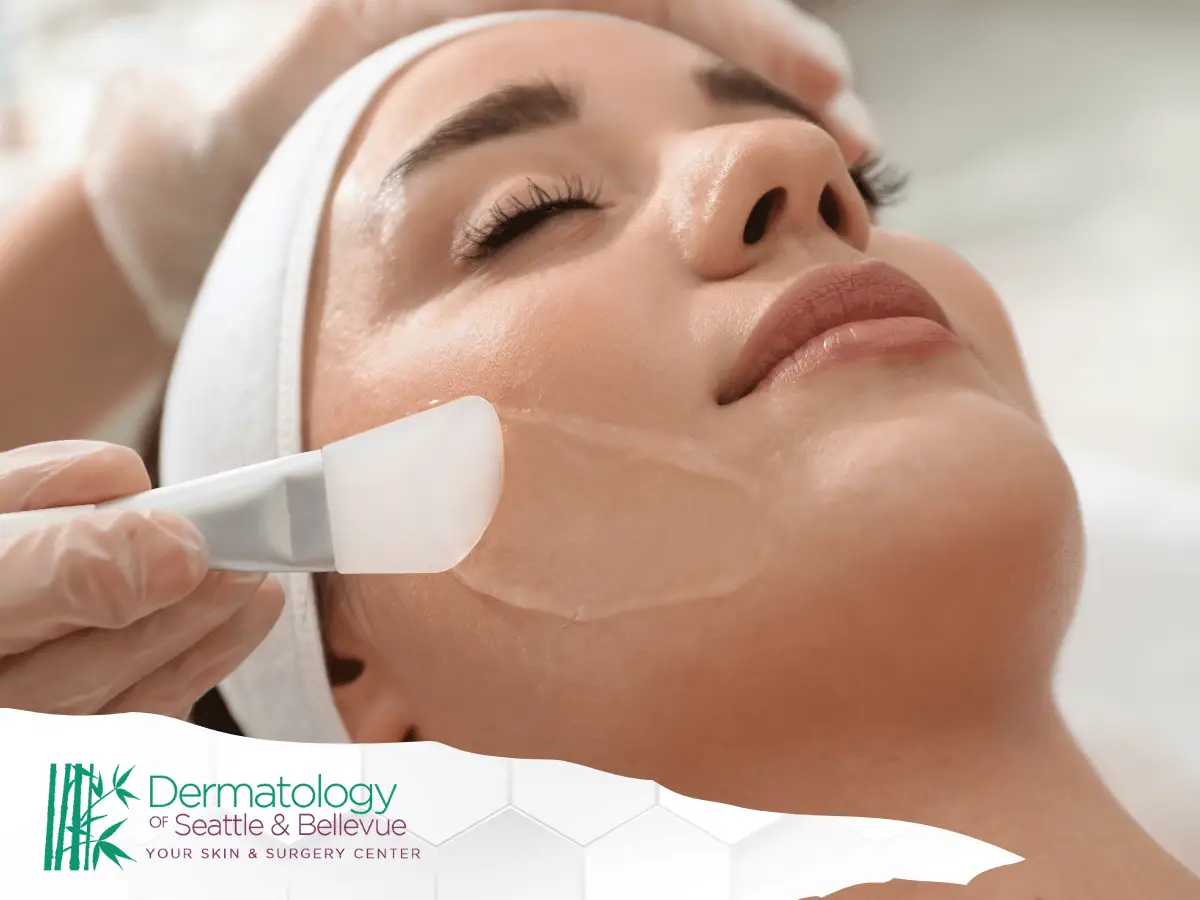 Close-up of woman receiving facial treatment with applicator on cheek.