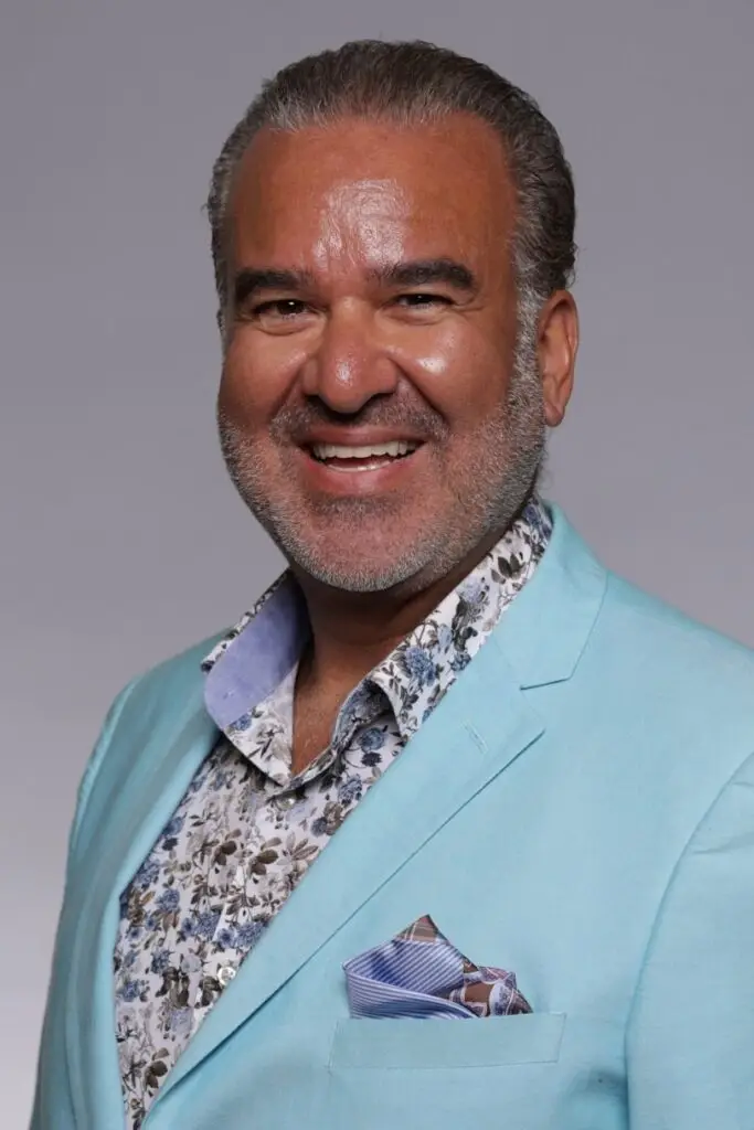 dr. levy smiling in light blue blazer and floral shirt.