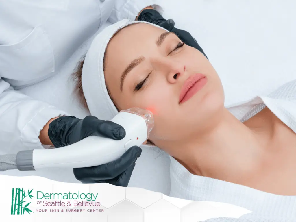 Woman receiving facial laser treatment from gloved clinician in white robe