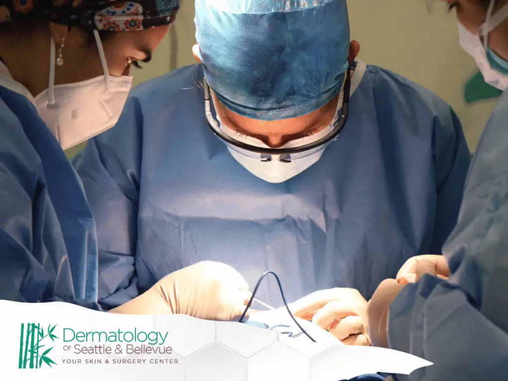 Surgeons in blue scrubs and masks performing a focused procedure