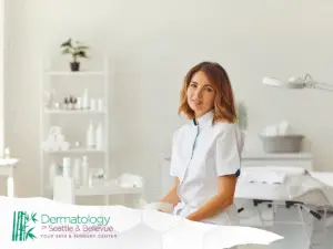 Female medical professional in white coat sitting in bright treatment room