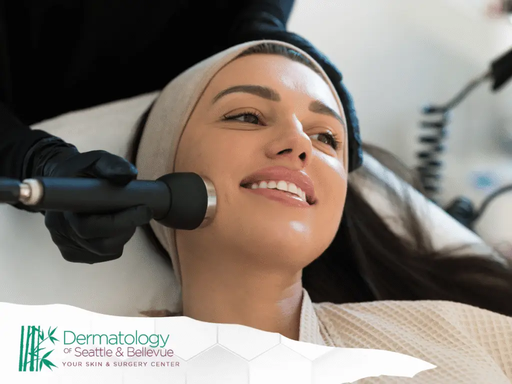 Woman receiving facial skin treatment with handheld device, smiling relaxed.