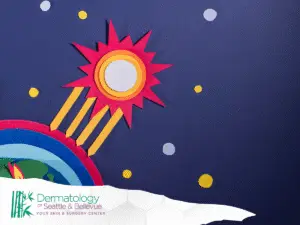 Colorful paper-cut sun and Earth with rays in dark space.