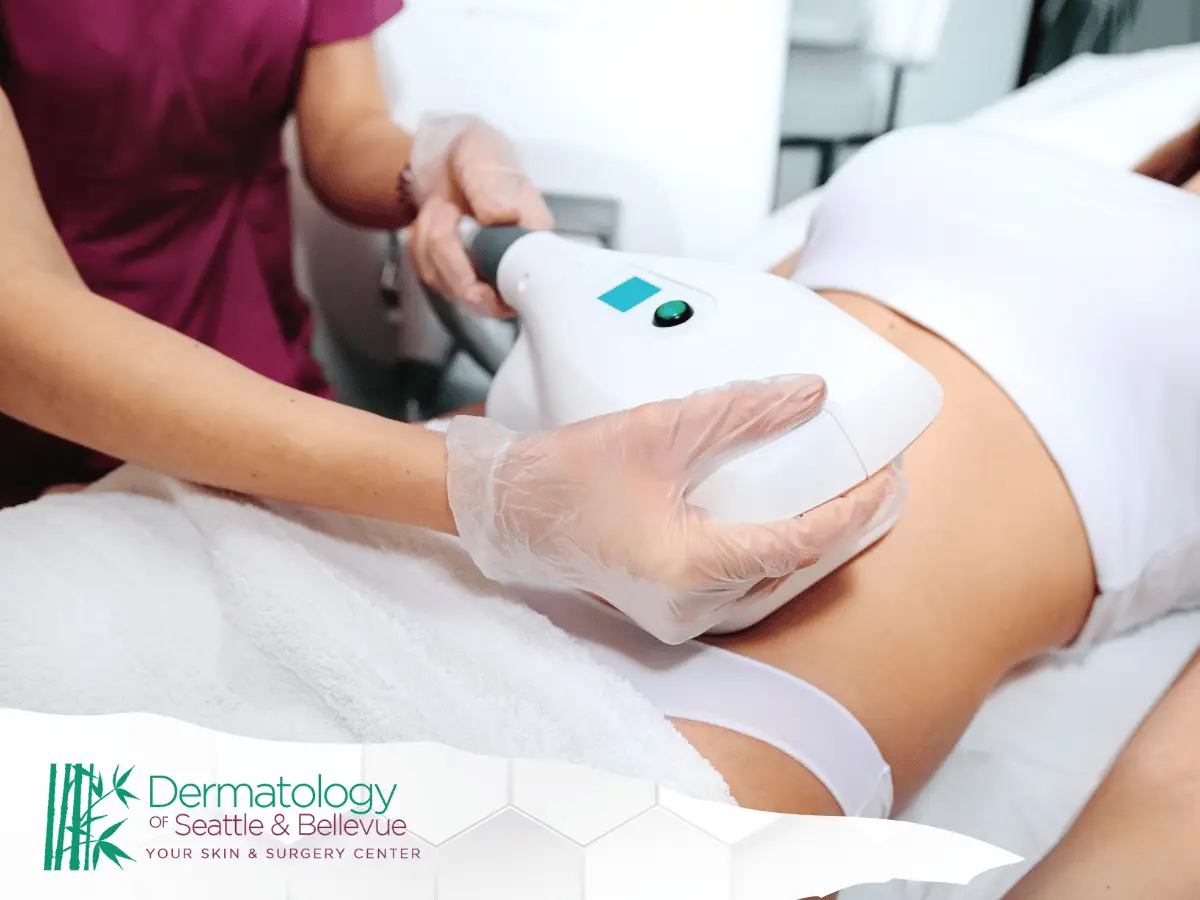 Clinician using handheld device on patient’s abdomen during treatment