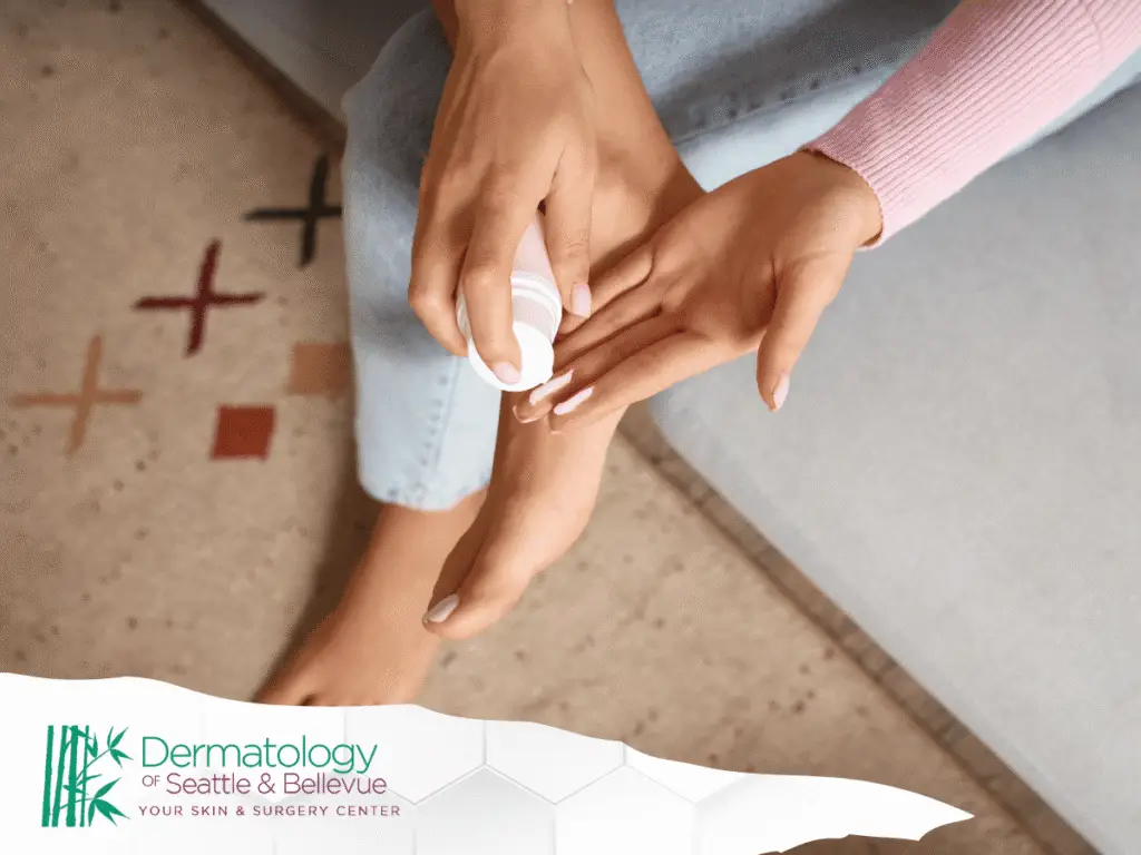 Person applying cream to bare foot while sitting on couch