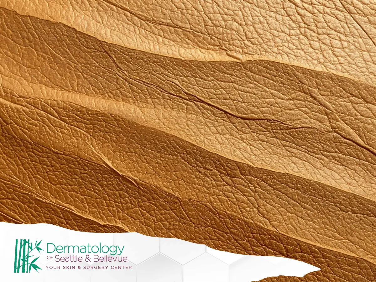 Close-up of textured golden-brown leather with layered folds.