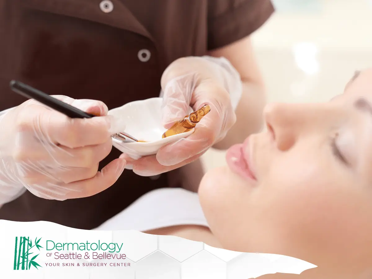 Gloved hands preparing facial treatment near relaxed woman’s face