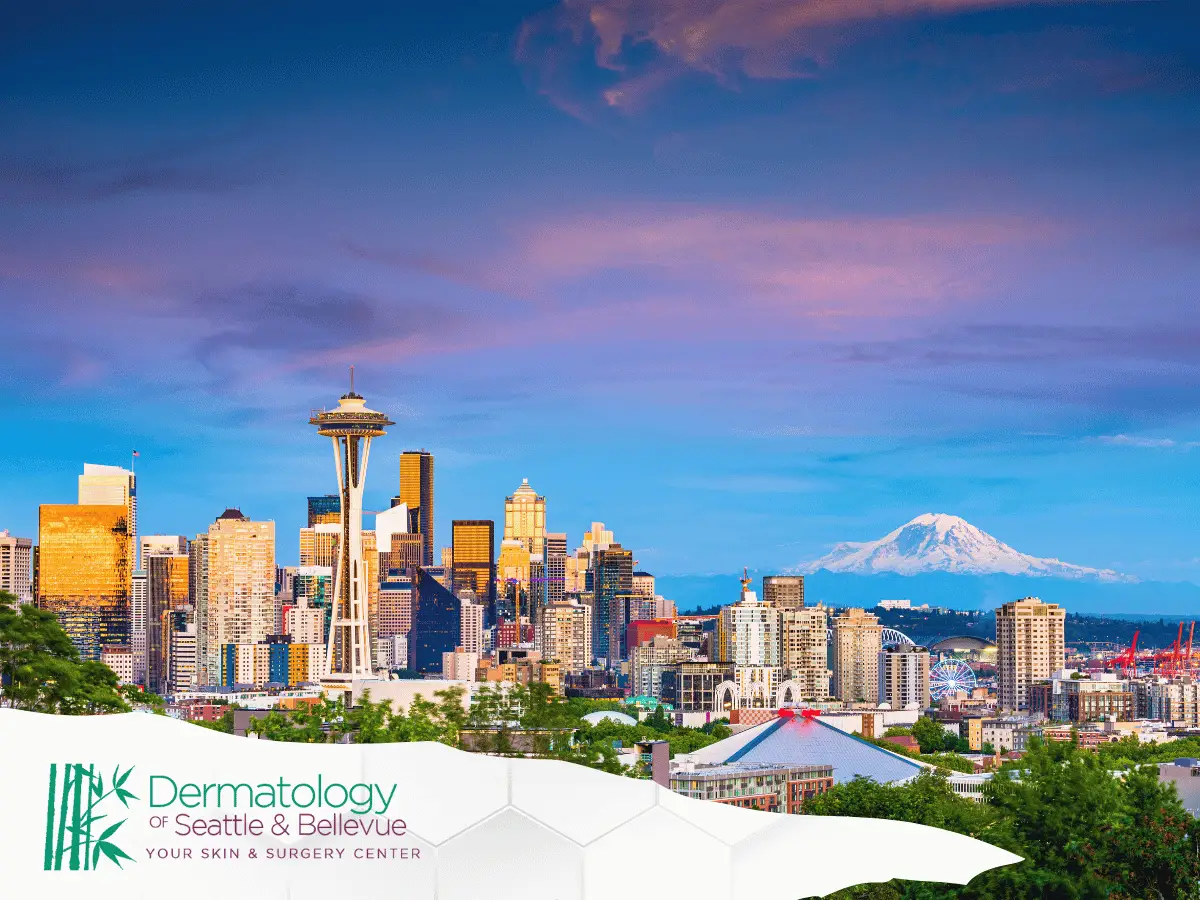 Seattle skyline at sunset with Space Needle and distant snow-capped mountain