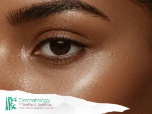 Close-up of a brown eye and eyebrow on smooth, glowing skin