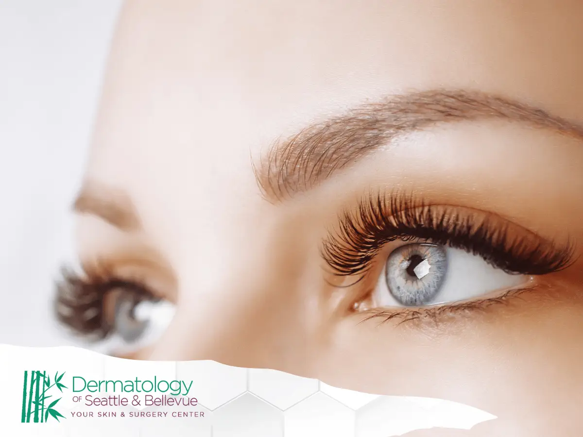Close-up of blue eyes with long eyelashes and groomed eyebrows.