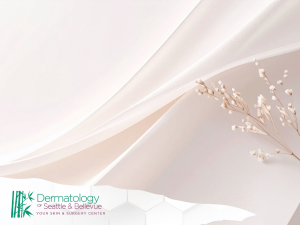 Soft pink fabric background with delicate white flower stems.