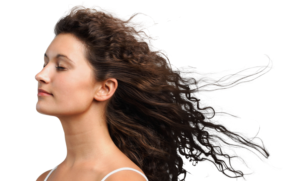Side profile of woman with long curly hair blowing sideways